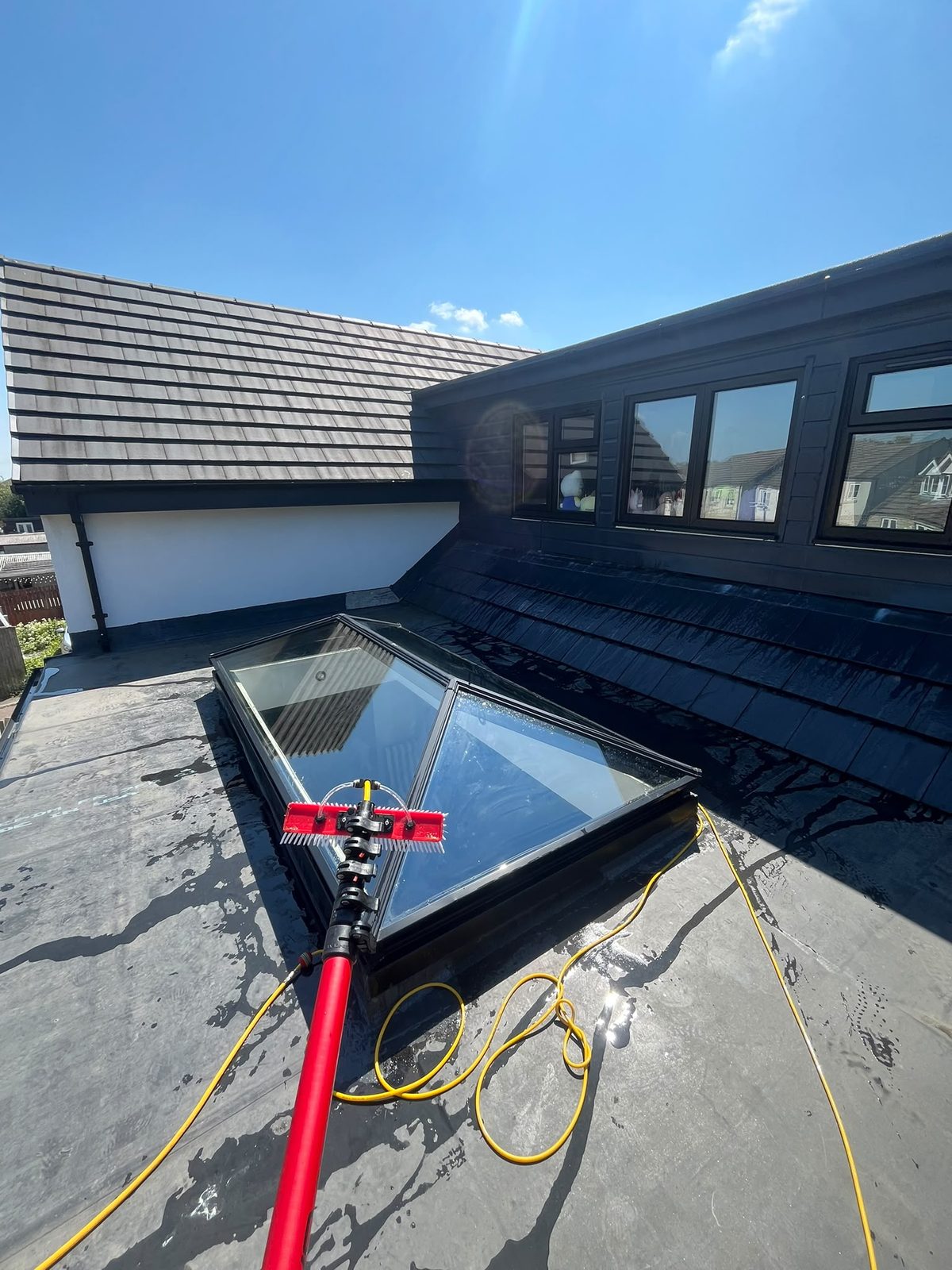 Pure-water brush cleaning a roof lantern
